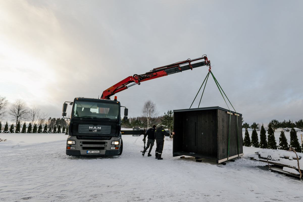 DEIZ outdoor sauna being installed by crane on a prepared site